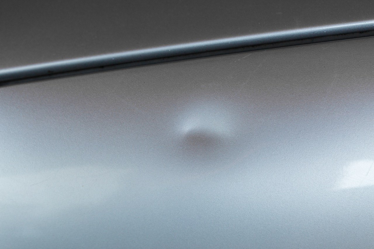 minor Dent on car with silver paint image